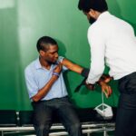 A healthcare professional checks a patient's blood pressure in a clinic in Lagos, Nigeria.