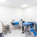 A clean and equipped medical examination room with diverse healthcare tools.