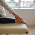 Close-up of a woman's foot receiving a relaxing massage in a wellness setting.