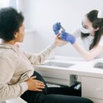 A pregnant woman enjoying a manicure at a modern nail salon for self-care and relaxation.