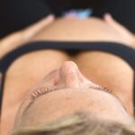 A pregnant woman relaxing in a prenatal yoga session focusing on breathing and mindfulness.