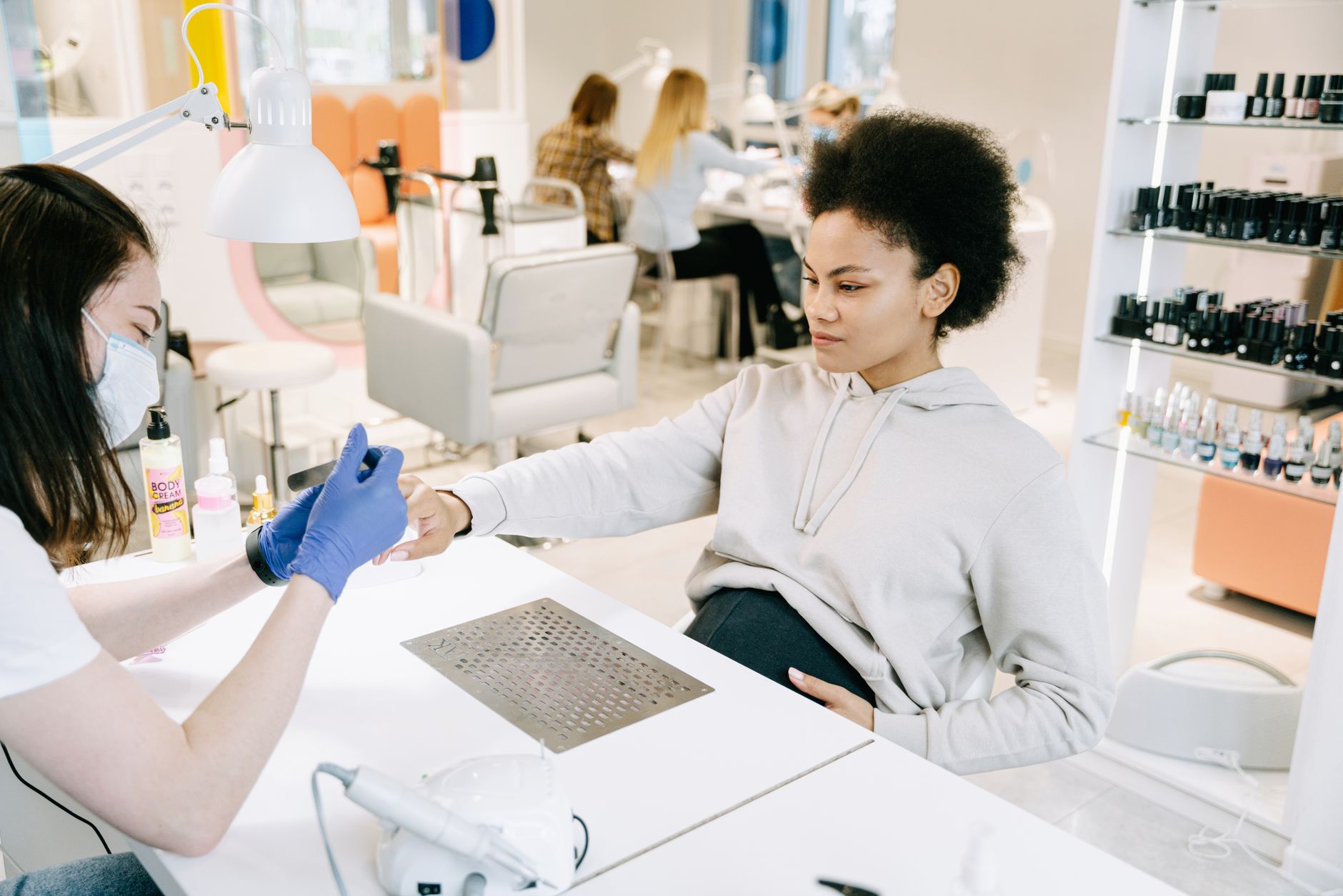 Pregnant woman enjoying a manicure at a salon. Relaxing self-care moment.
