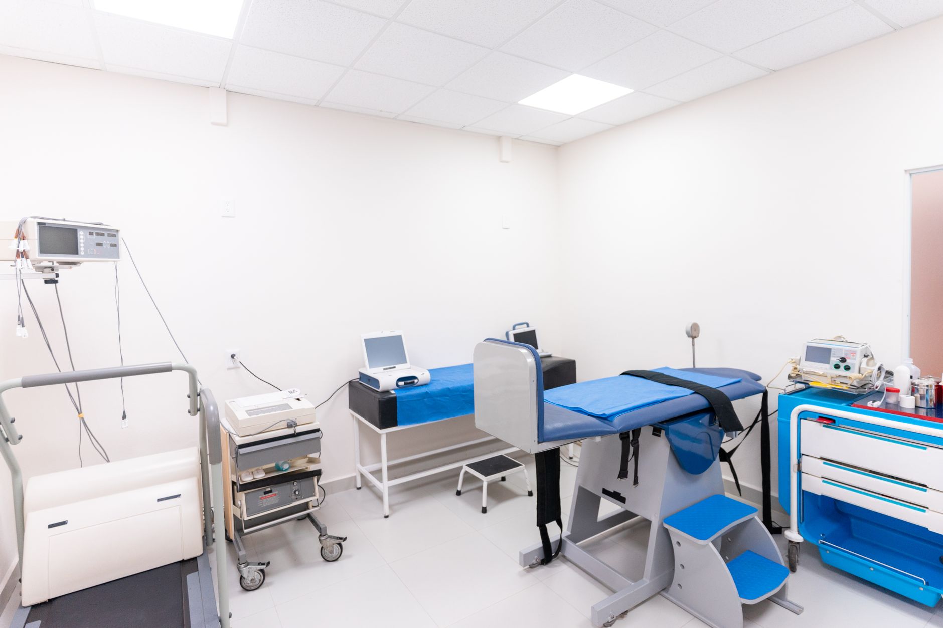 A clean and equipped medical examination room with diverse healthcare tools.