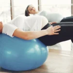 Pregnant women engaging in low-impact exercise with fitness balls indoors.